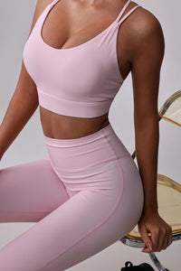 Pink activewear set with sports bra and high-waisted leggings for yoga or gym workouts