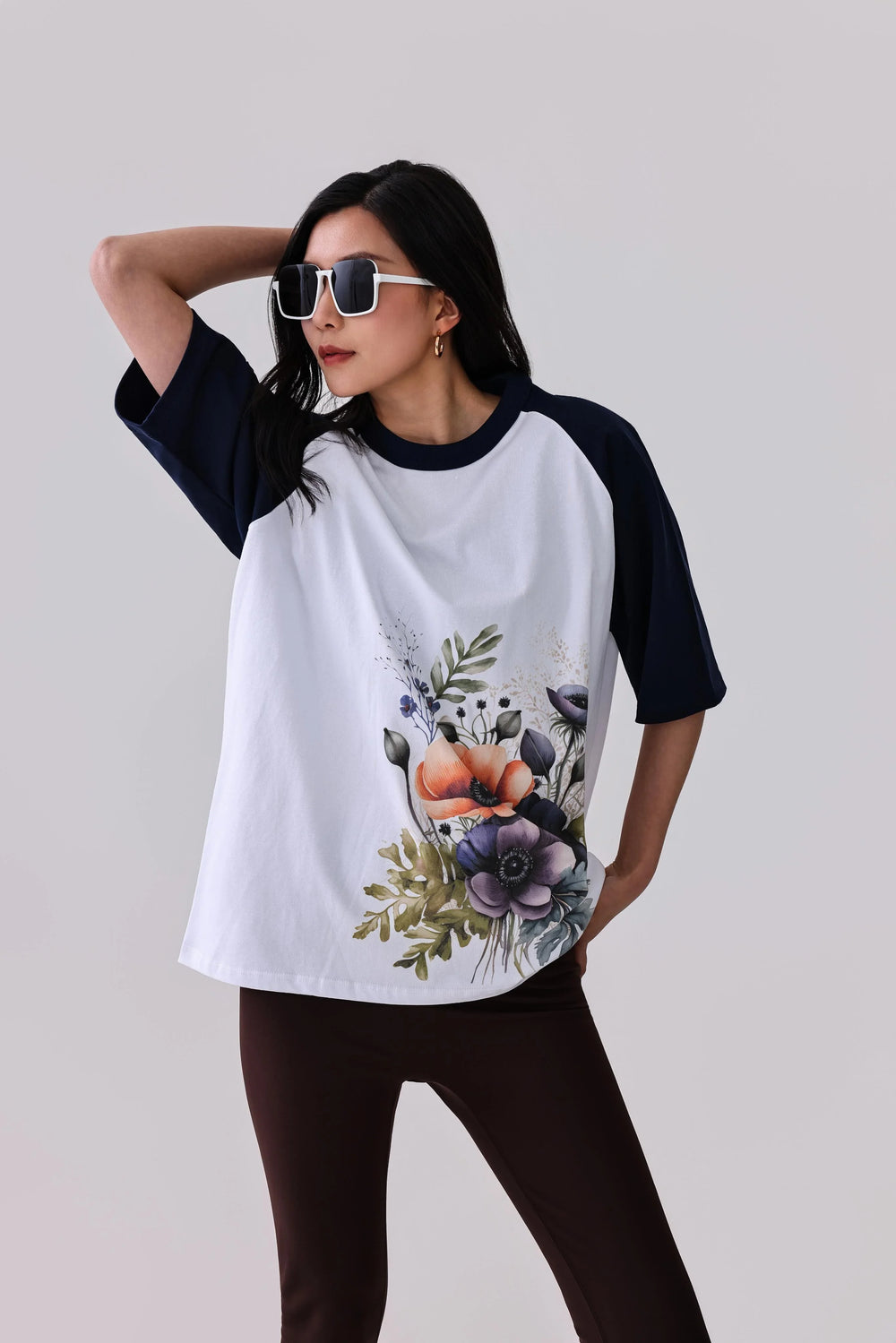 Floral print raglan tee with navy sleeves, styled with leggings for activewear