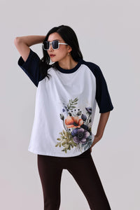 Floral print raglan tee with navy sleeves, styled with leggings for activewear