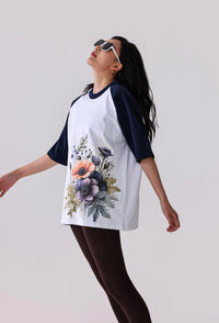 Floral print raglan t-shirt with navy sleeves, paired with leggings for activewear style