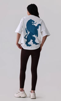 Woman wearing white graphic tee with blue lion print, black leggings, and white sneakers for activewear