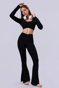 Woman in black long sleeve crop top and flared leggings with white headphones, activewear set