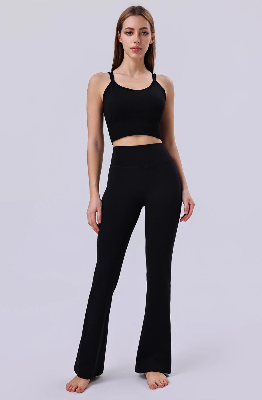 Black activewear set with crop top and flared leggings for yoga or gym