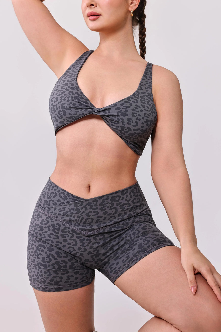 Grey leopard print activewear set with twist-front sports bra and high-waisted shorts for gym or yoga
