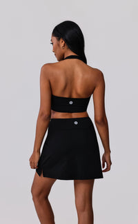 Black halter sports bra and matching tennis skirt set for activewear and gym wear