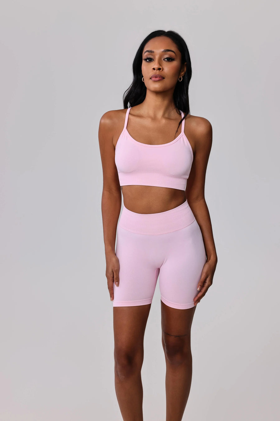 Light pink activewear set with sports bra and biker shorts for gym or casual wear