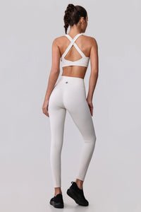 White high-waisted leggings and crisscross back sports bra activewear set for women