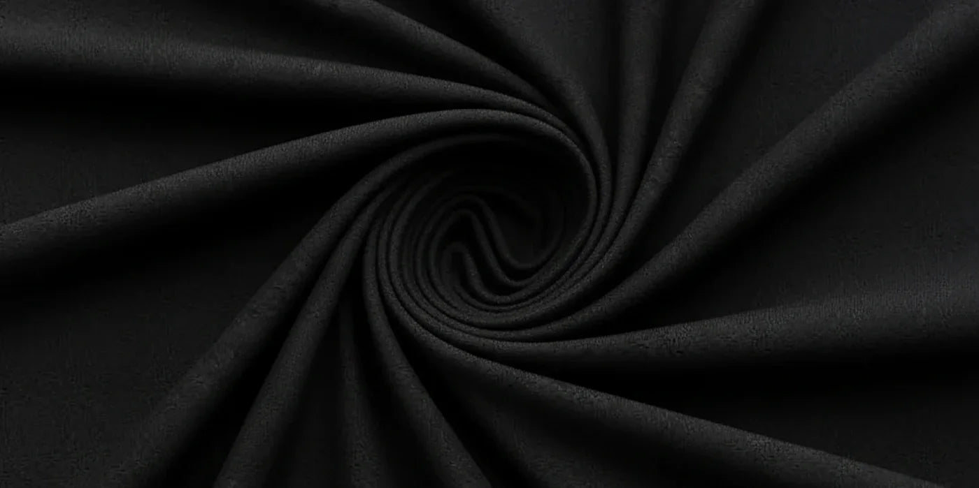 Black activewear fabric swirled in a spiral, showcasing soft texture and stretch for leggings and sports bras